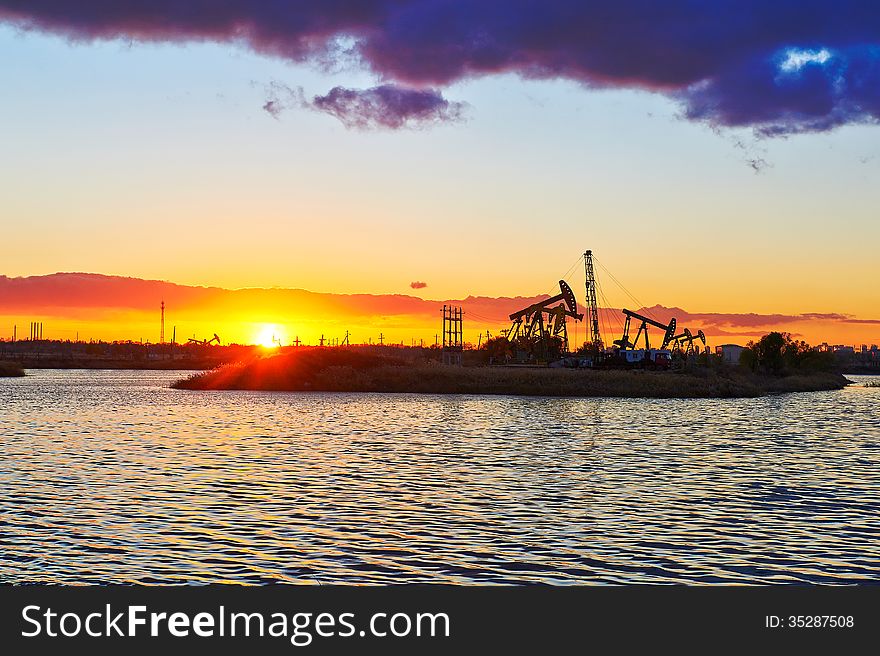 The Oil Sucking Machine And Lake Sunset