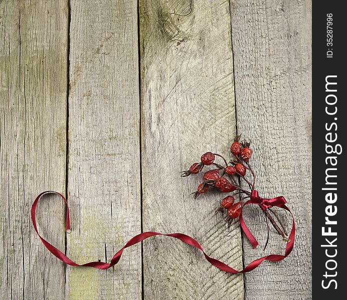 Vintage frame with berry bunch on wooden background