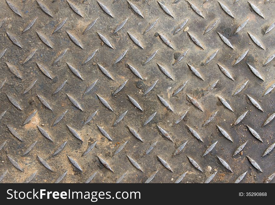 Old diamond plate background and small sand with dirt