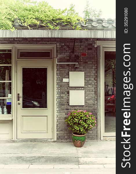 Flowerpot at store entrance, China.