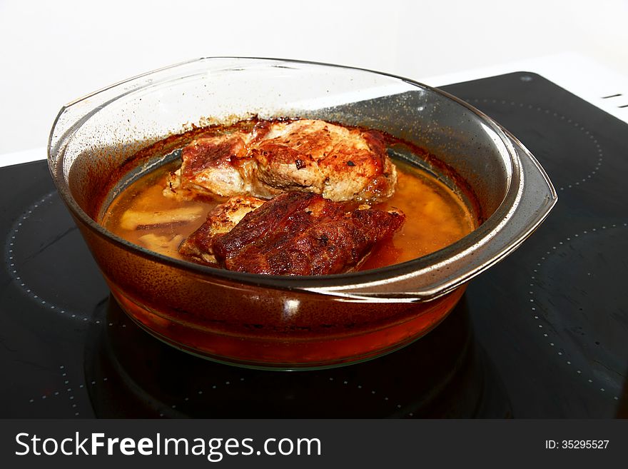 Natural pork cutlets in a glass bowl. Natural pork cutlets in a glass bowl