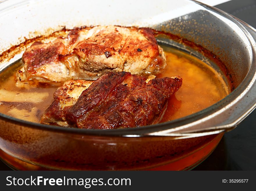 Detail of natural cuttings in a glass bowl, pork chops in brine