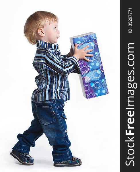 Little boy going with big box in his hands, isolated on white