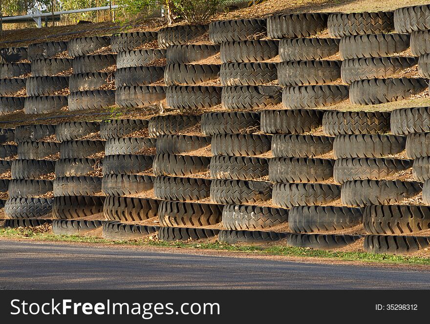 Ripped and tear apart in a rough or vigorous manner heavy transport mine truck wheel piled as blocks