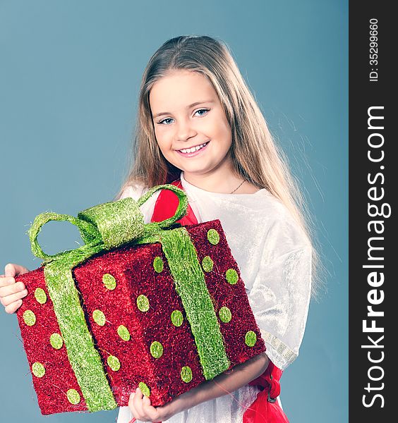 Little girl holding a big red gift boxes. Little girl holding a big red gift boxes