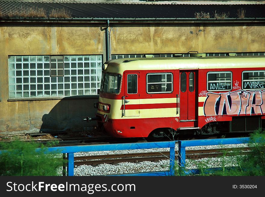Red train locomotive with graffiti