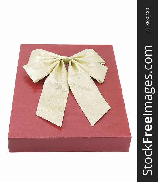 Christmas or other holiday present with gold bow isolated on white