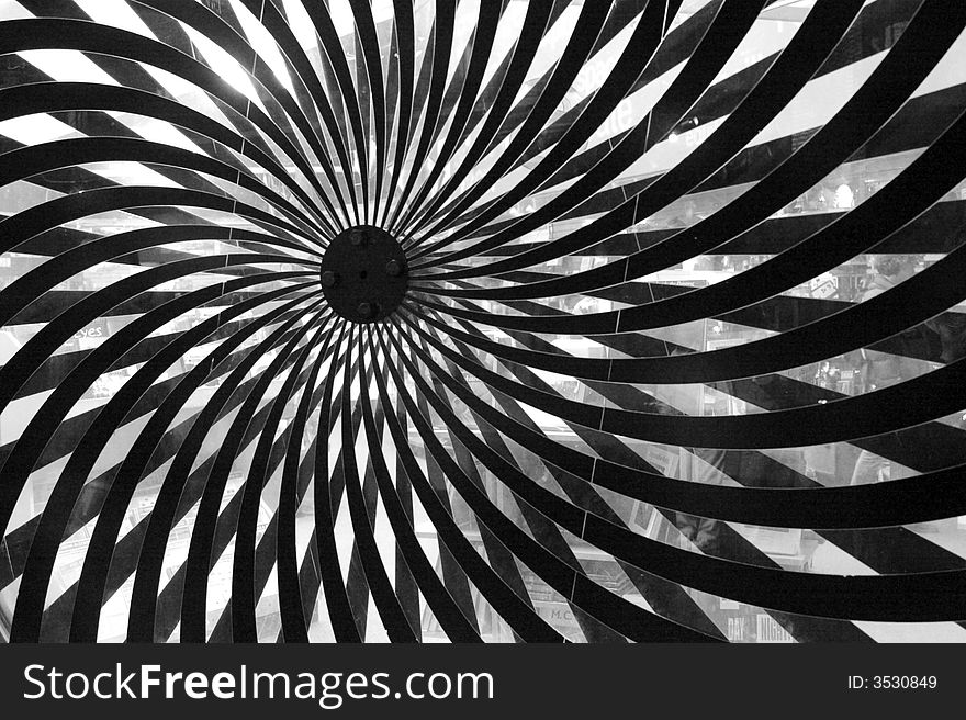 Abstract metal pinwheel structure in black and white.