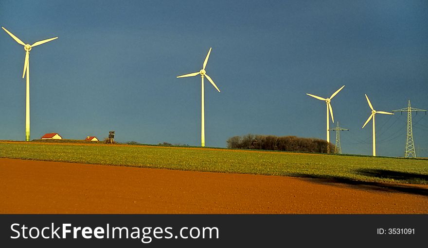 Windmills and field at the horizon. Windmills and field at the horizon