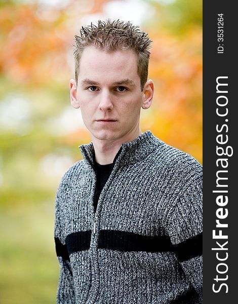 Boy in autumn colors facing the audience