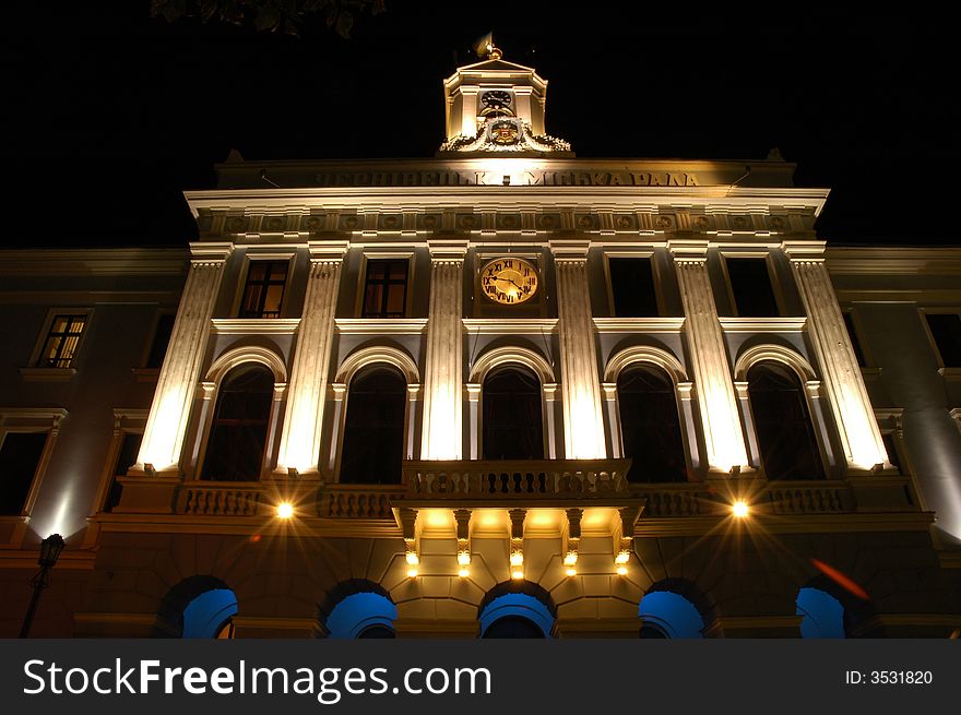 Night look of the administrative building with the balcony and clock. Night look of the administrative building with the balcony and clock