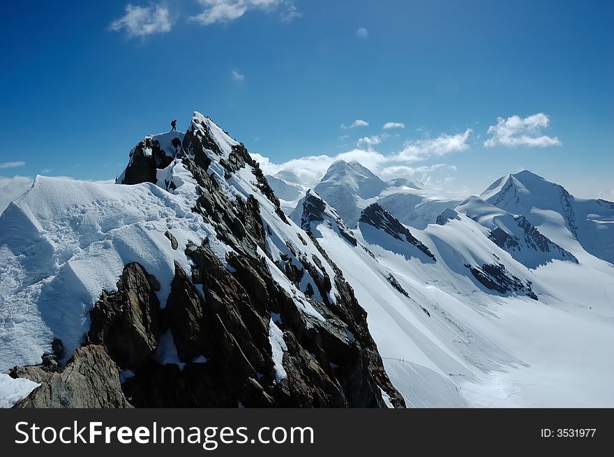 Climbers, on background the peaks and glaciers of Monte Rosa massif, west Alps, Europe. Climbers, on background the peaks and glaciers of Monte Rosa massif, west Alps, Europe