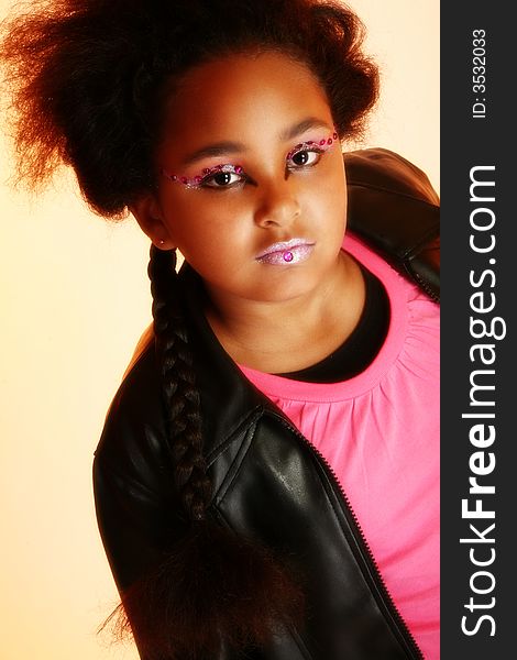 Beautiful ten year old African American girl with artistic cosmetics. Beautiful ten year old African American girl with artistic cosmetics.