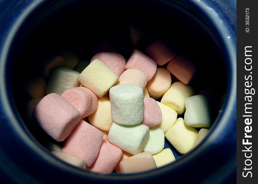 Rainbow marshmallows inside blue sugar bowl. Rainbow marshmallows inside blue sugar bowl