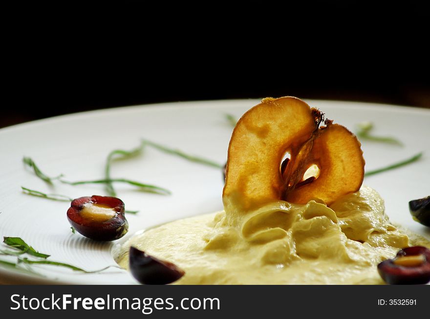 Apple mousse decorated with dried apple and cherry. Apple mousse decorated with dried apple and cherry