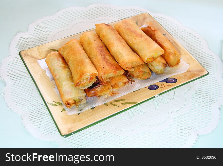 Deep fried springrolls served in a rectangular dish