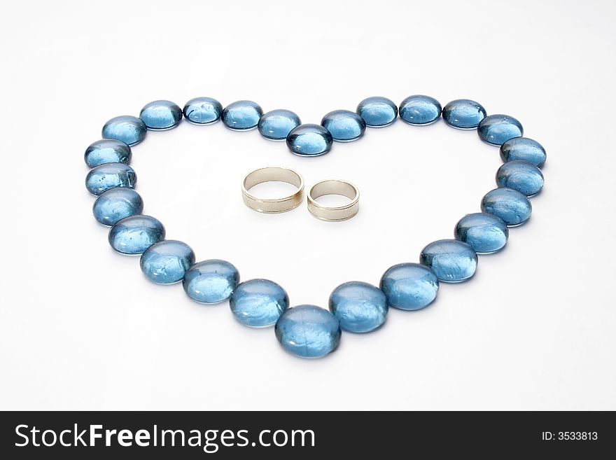 Wedding rings and blue pebbles