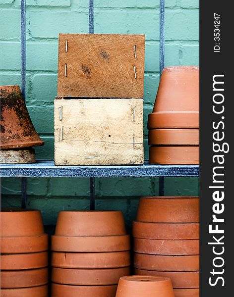 Two wooden boxes with space for advertisement surrounded with brown pots. Two wooden boxes with space for advertisement surrounded with brown pots