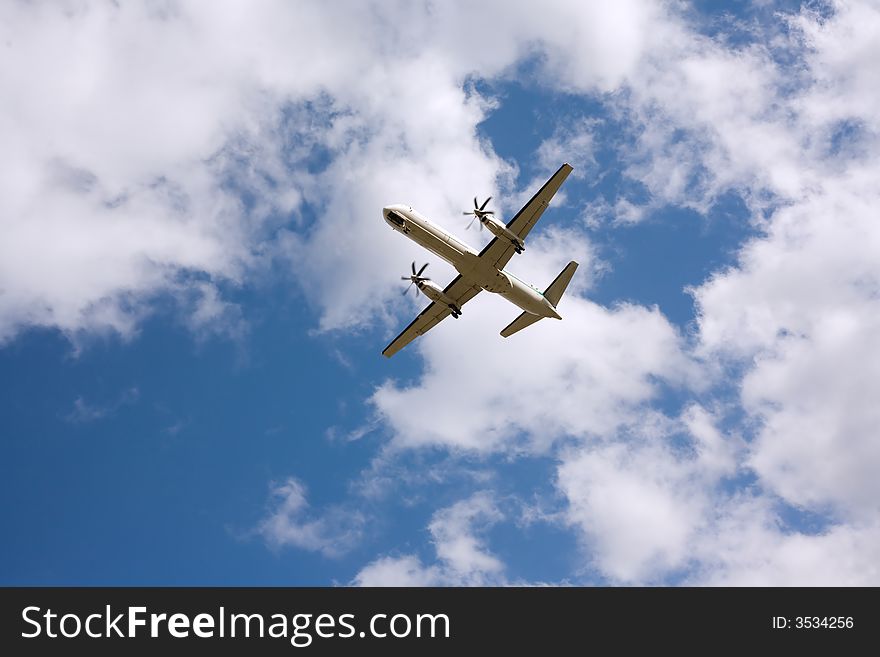 Airplane taking off, blue skies, back view