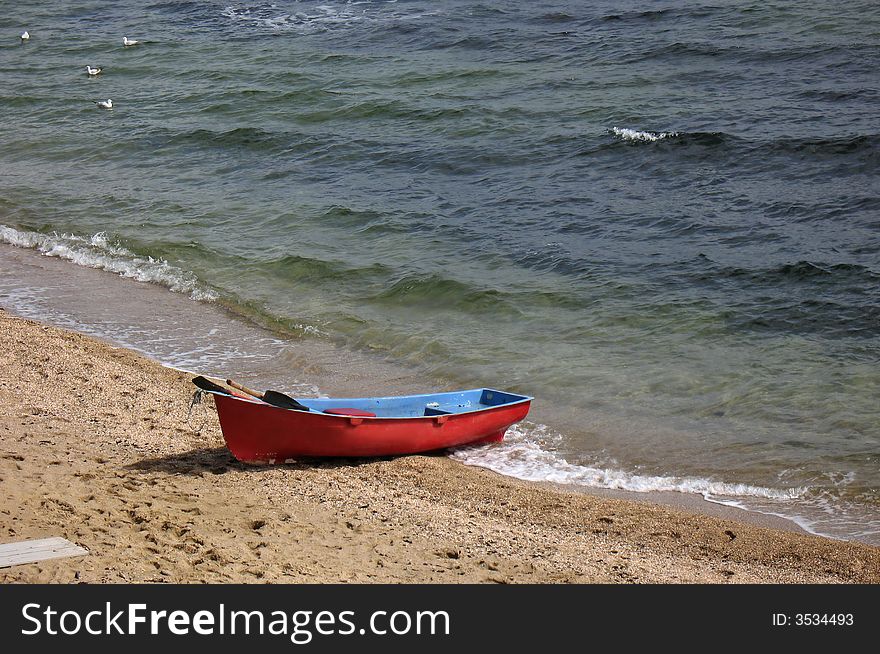 Lifeboat: red boat on a beach