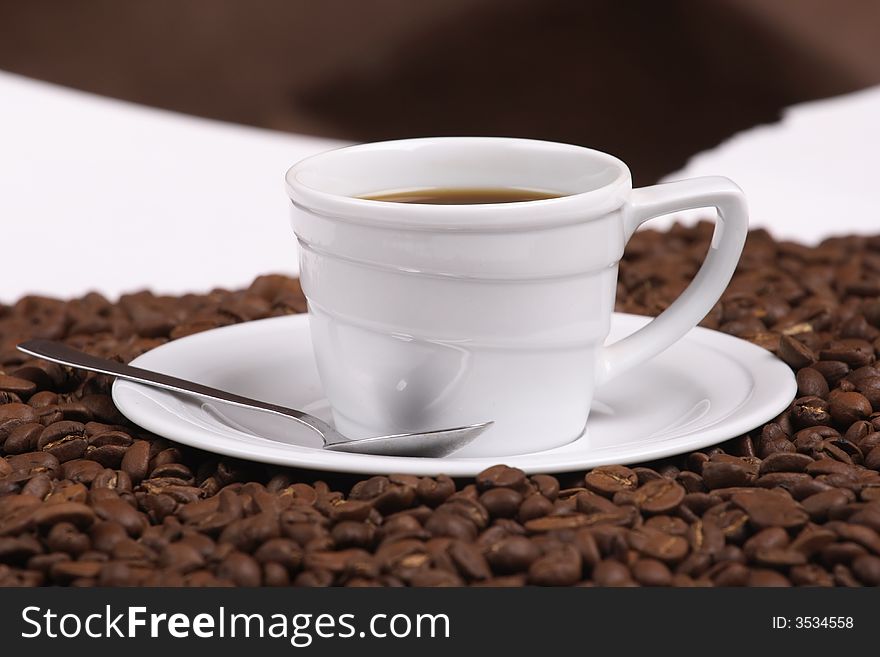 Cup with coffee, costing on coffee grain. Cup with coffee, costing on coffee grain