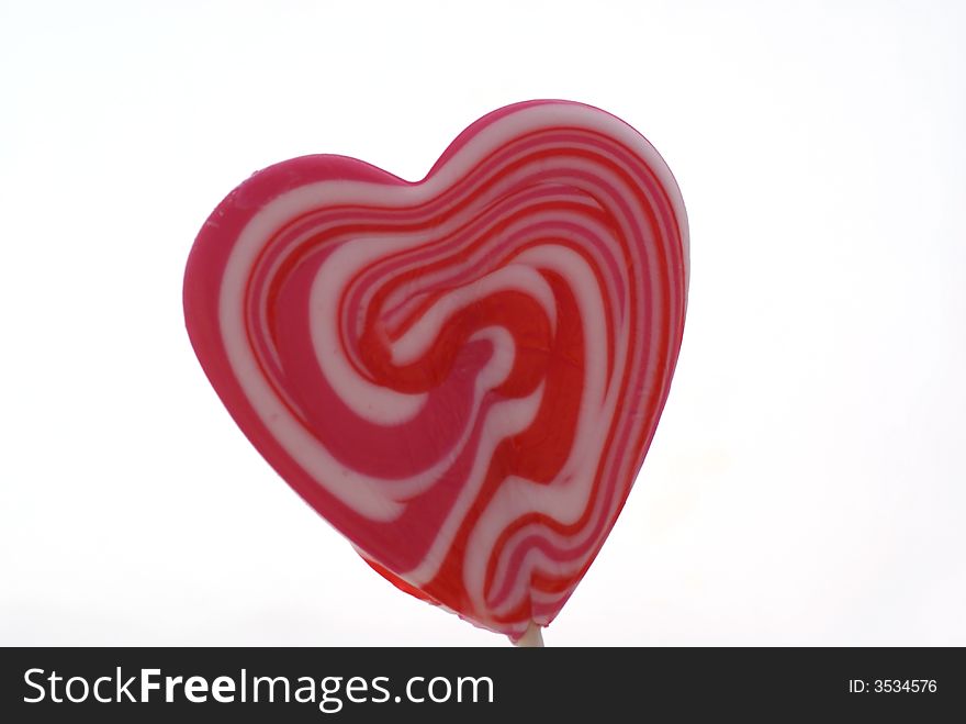 Heart shaped lollypop isolated on white. Heart shaped lollypop isolated on white.