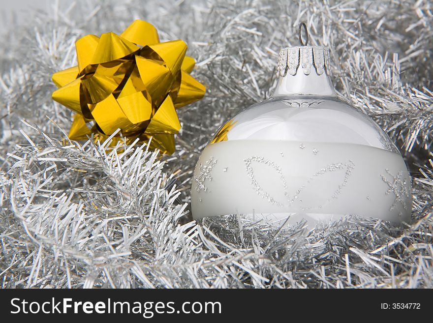 Silver Christmas or New Year decoration and an gold star. Silver Christmas or New Year decoration and an gold star