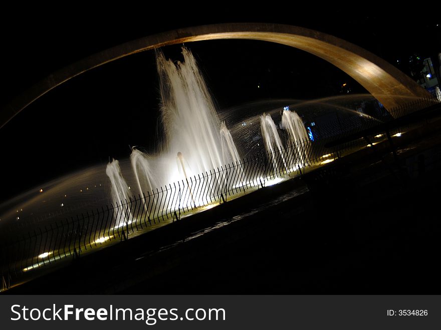 Fountain at night with blue moon in the background. Fountain at night with blue moon in the background