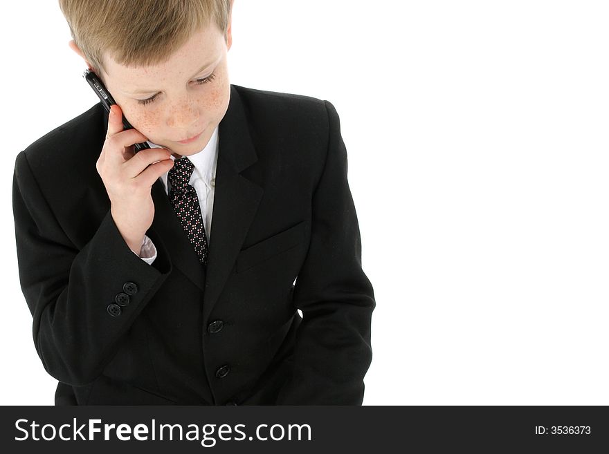 Little boy dressed in a suit sitting on cellphone. Little boy dressed in a suit sitting on cellphone