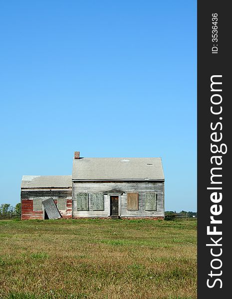 An Old abandoned house with grass and sky