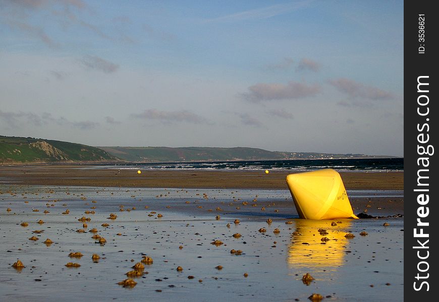 Yellow buoy on Urville beach