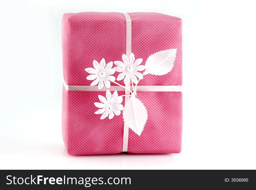 Pink gift box with white ribbon isolated on white