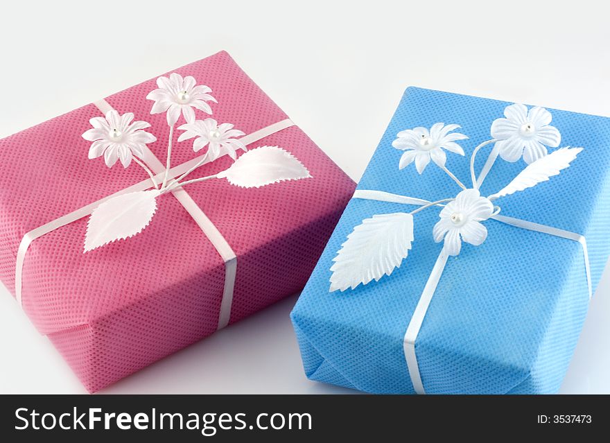 Pink and lightblue gift box with white ribbon isolated on white. Pink and lightblue gift box with white ribbon isolated on white