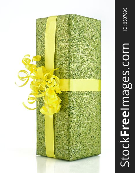 Green gift box with yellow ribbon isolated on white