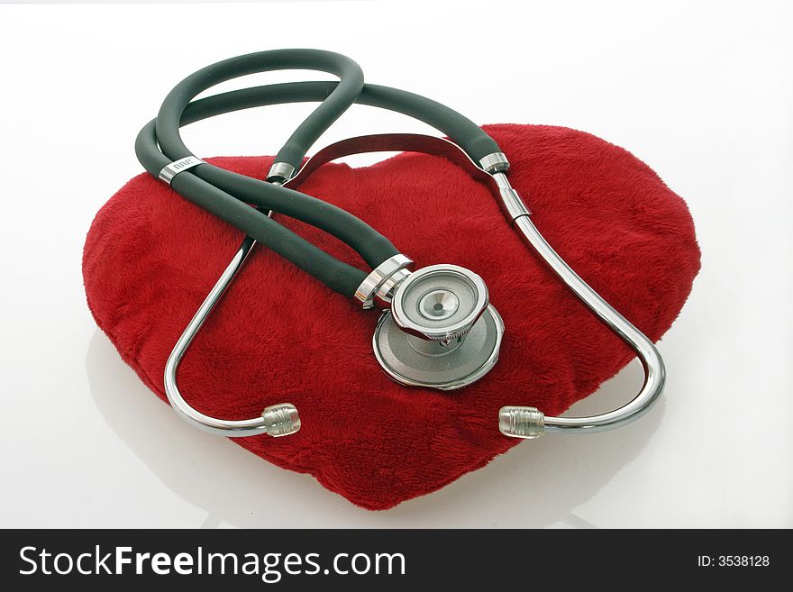 Stethoscope on red velvet heart on bright background