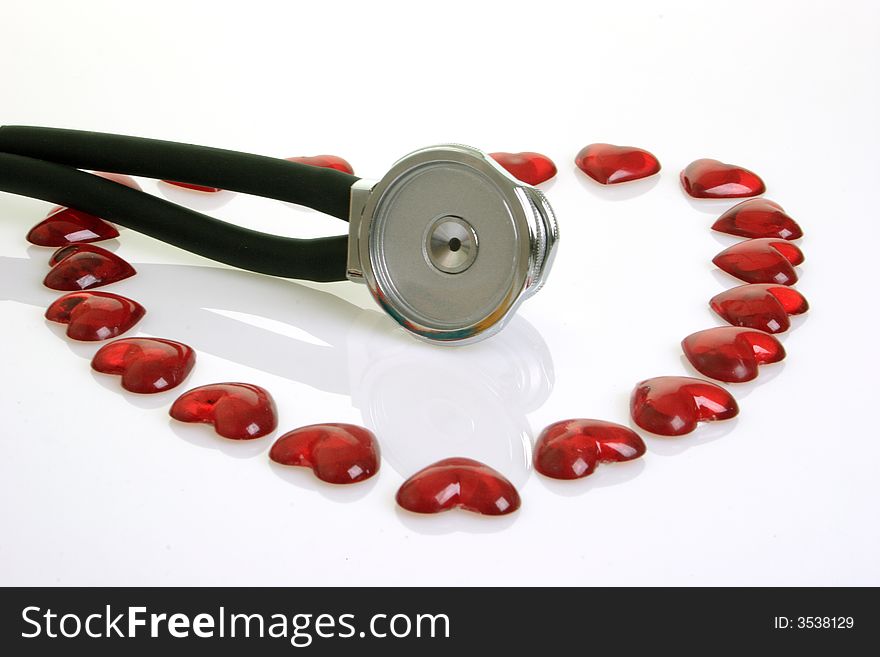Stethoscope with red decoration hearts on bright background