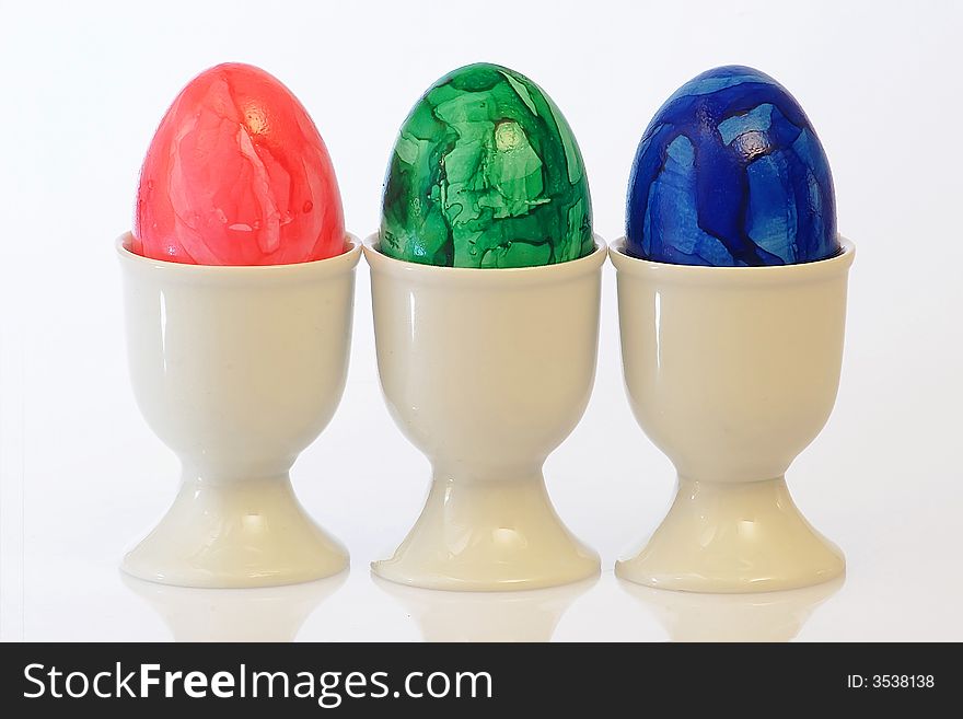 Three colourful easter eggs on bright background