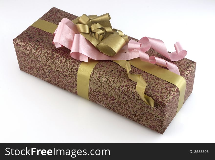 Many-coloured gift box with pink and gold ribbon isolated on white