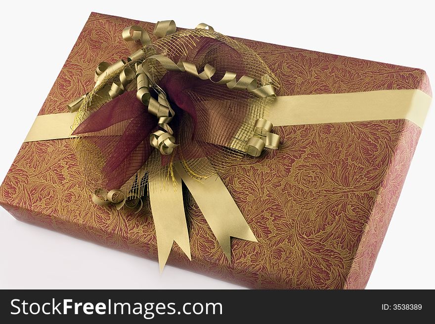 Many-coloured gift box with  gold ribbon isolated on white