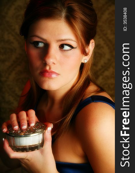 Beautiful young woman holding powder jar. Beautiful young woman holding powder jar.