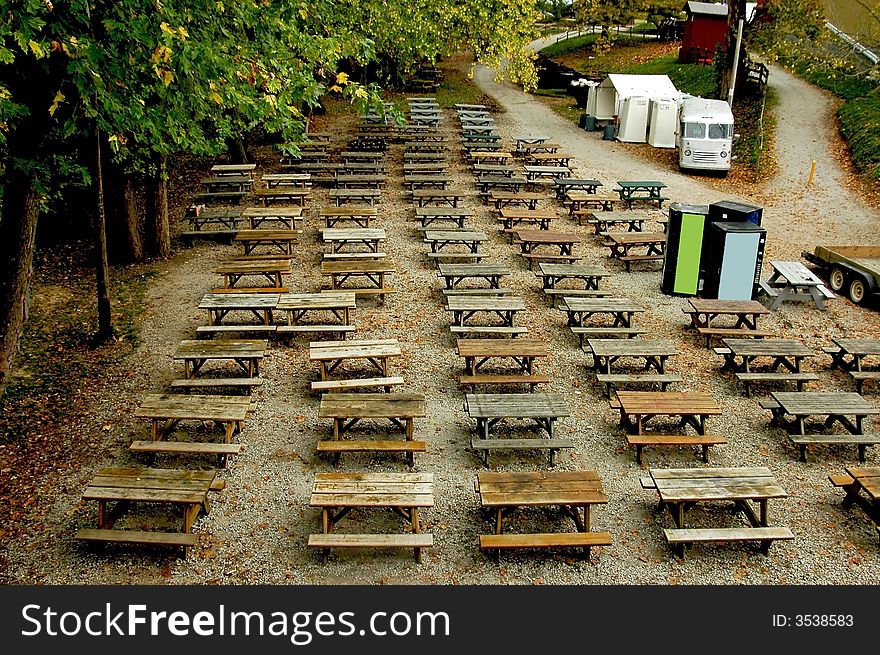 A picture of dozens of tables in a park area. A picture of dozens of tables in a park area