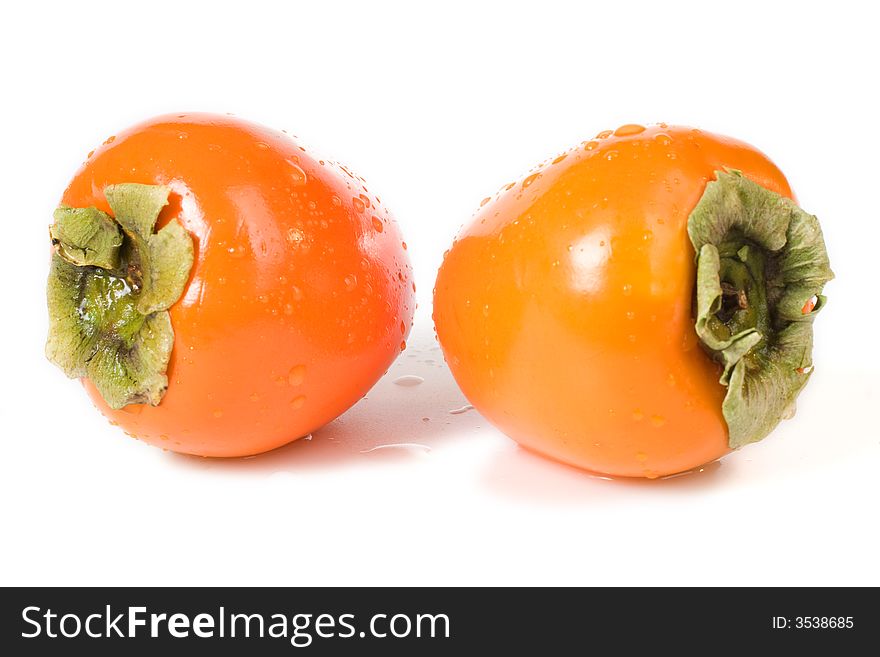 Two orange fresh Hachiya Persimmon fruits on white background. Two orange fresh Hachiya Persimmon fruits on white background