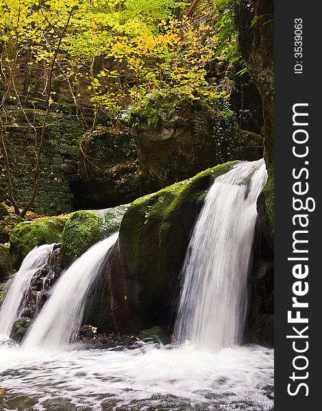 Waterfall with three outlets in a autumn forest