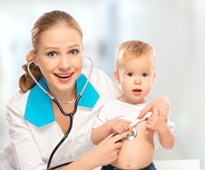 Baby And Doctor Pediatrician. Doctor Listens To The Heart With S Stock Image