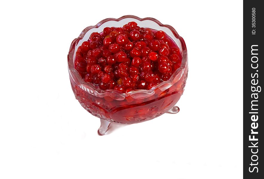 Bright red berries in a crystal vase filled with sugar syrup. Presented on a white background. Bright red berries in a crystal vase filled with sugar syrup. Presented on a white background.