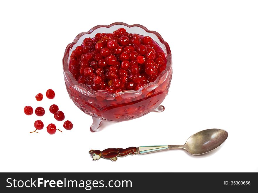 Bright red berries in a crystal vase filled with sugar syrup. Presented on a white background. Bright red berries in a crystal vase filled with sugar syrup. Presented on a white background.