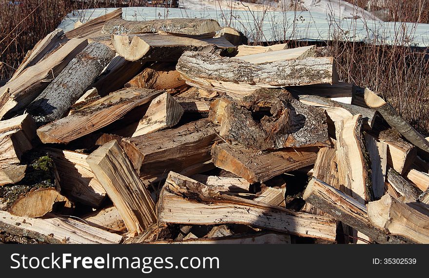 Haphazard pile of firewood just freshly split. Haphazard pile of firewood just freshly split