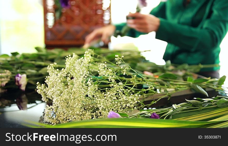 Woman florist arranging flower bouquet