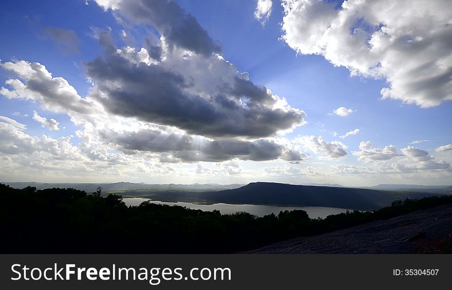 Cloudscape sun burst ray timelapse vivid blue sky setting sun