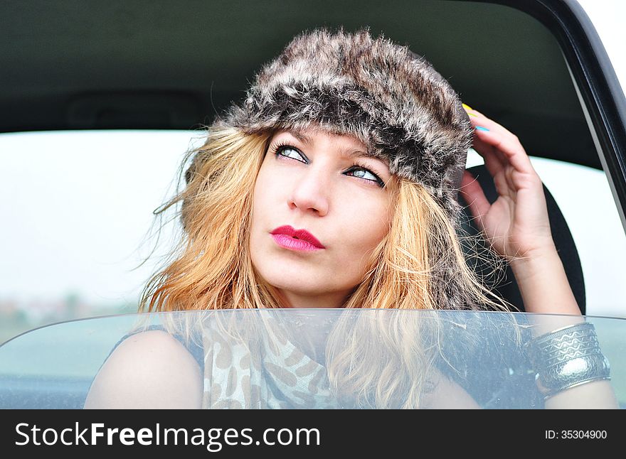 Fashion Girl Sitting In A Car